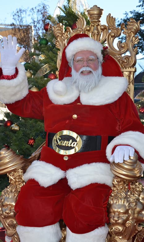 Santa clause sitting on a golden throne.