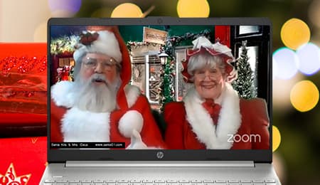 A laptop with santa claus and a woman dressed in santa claus.